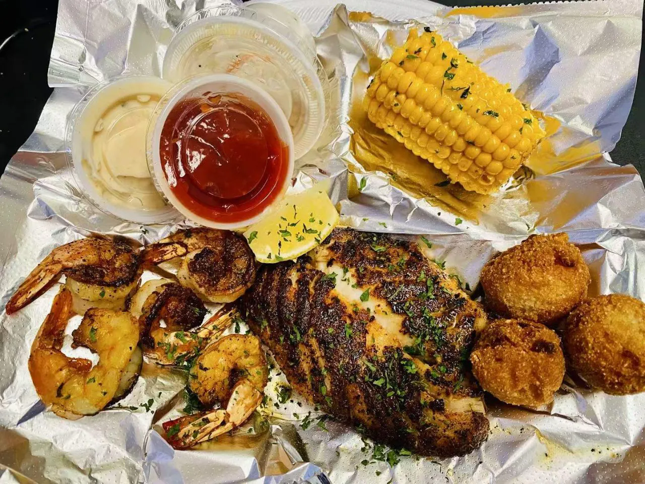 Blackened chicken, shrimp and hush puppies with corn at Bayou Fresh Seafood Grill & Sushi a Asian Fusion Restaurant in Jasper