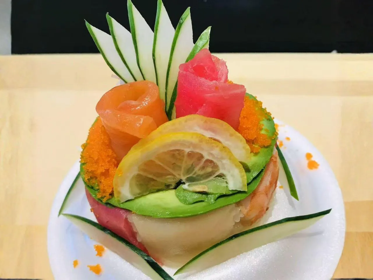 Layered sushi tower with salmon, tuna, avocado and tobiko at Bayou Fresh Seafood Grill & Sushi a Asian Fusion Restaurant in Jasper